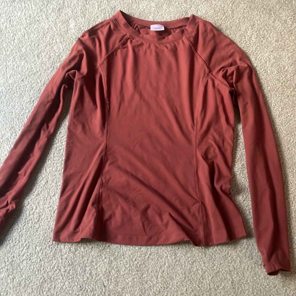 Long sleeved burnt orange shirt.